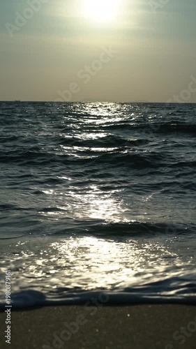 Golden Sunset Over Koh Libong Beach in Trang Thailand with Shimmering Sea Waves and Tropical Coastal Scenery