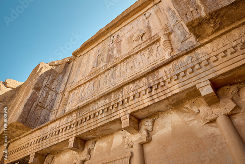 Ancient persia reliefs on rock over the tomb in Persepolis, Iran