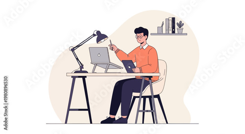 Man working at desk with laptop and tablet, modern home office setup