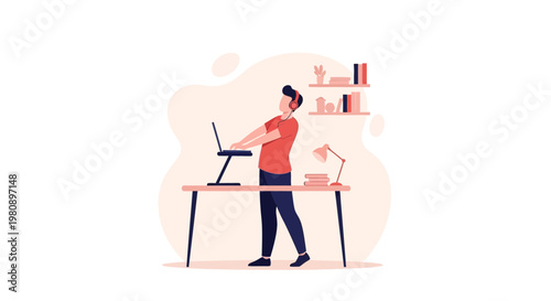 Man working on laptop at standing desk, modern home office, ergonomic setup