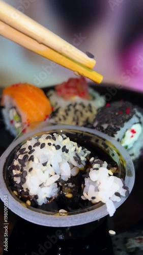 Philadelphia rolls, close-up sushi. Vertical video. Salmon sushi, assorted rice rolls. Ginger and chopsticks.