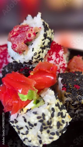 Philadelphia rolls, close-up sushi. Vertical video. Salmon sushi, assorted rice rolls. Ginger and chopsticks.