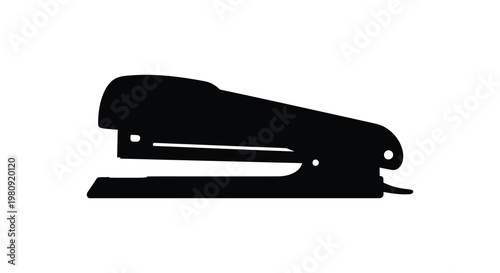 A stark black silhouette of a common office stapler clearly defined silhouette
