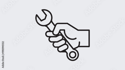 A hand holding a wrench for repair and maintenance work