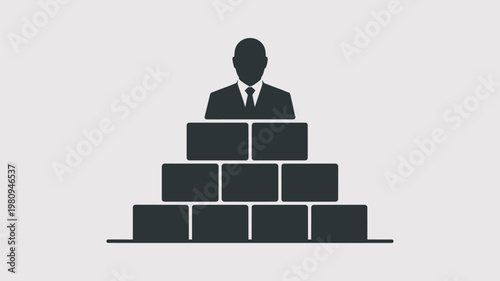 A businessman standing on a foundation of blocks, symbolizing leadership and success