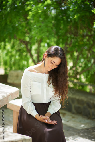 Portrait of a young beautiful brunette woman against the backdrop of the nature of northern Israel