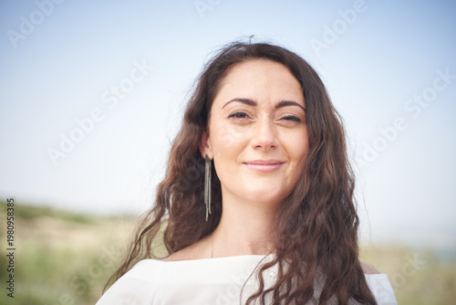 Portrait of a young beautiful brunette woman against the backdrop of the nature of northern Israel