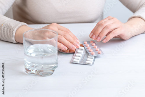 Woman preparing medication with water, daily treatment and healthcare routine concept