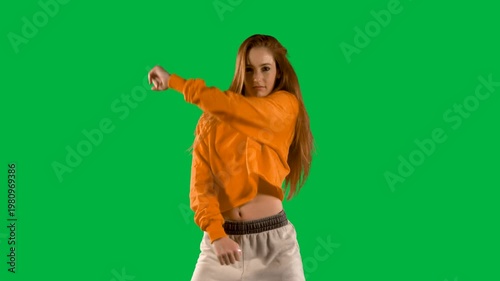Beautiful woman dancing against black background