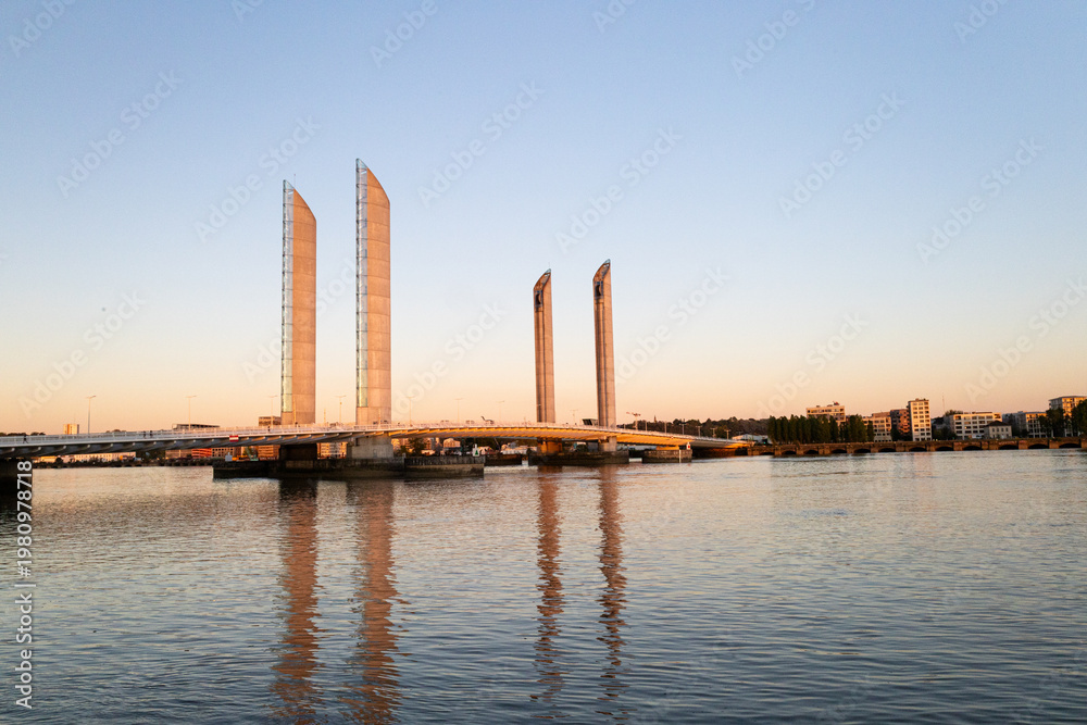 Obraz premium Chaban-Delmas Lift Bridge at Golden Hour Reflected in Garonne River Bordeaux France