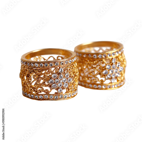 Close-up shot of two ornate, golden rings with embedded jewels and intricate designs