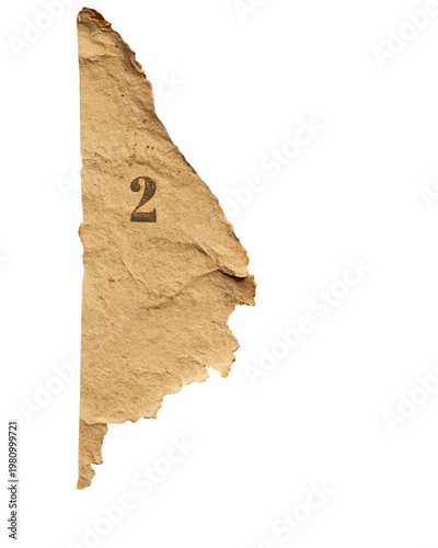 Torn, aged paper segment, bearing the number 2, set against a black backdrop