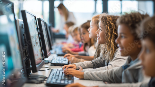 A group of schoolchildren use desktop computers in a modern classroom.