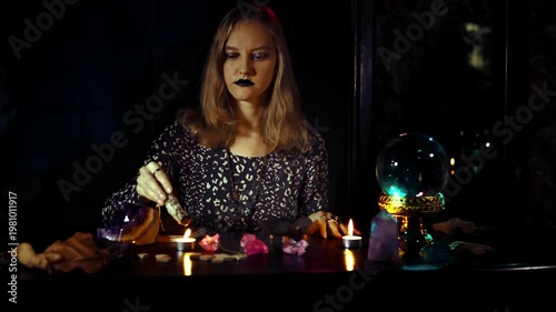 Mystical fortune telling ritual with a woman psychic crystal ball candles smoke amethyst and runes in a dark room creating a sacred cinematic atmosphere