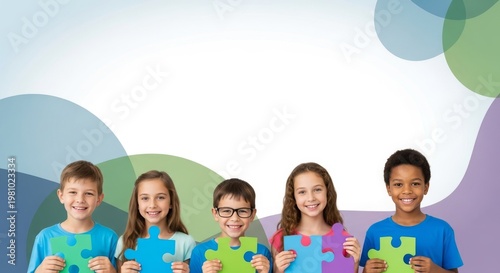 Diverse children holding puzzle pieces, smiling against a colorful, abstract background. Elementary students with puzzle pieces in a studio.