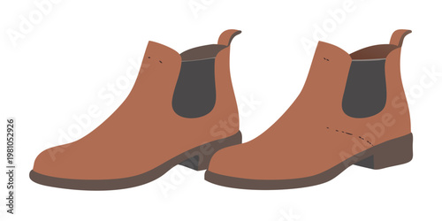 A pair of brown leather chelsea boots on a dark background
