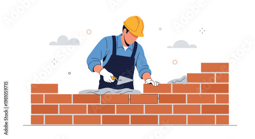 Professional construction worker wearing a yellow hard hat and blue overalls carefully laying bricks to build a solid house wall.