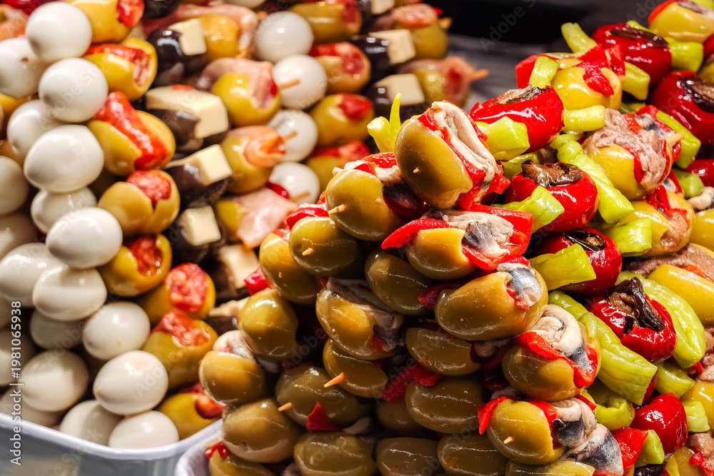 Obraz premium Skewers with olives, peppers or other ingredients in the form of banderillas in San Miguel market, Madrid.