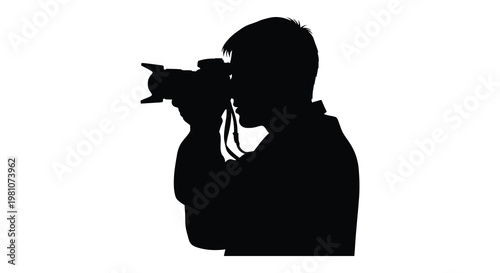 A photographer intently focuses while capturing a shot presented as a silhouette