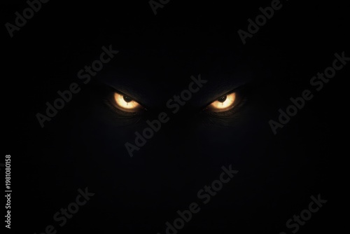 Glowing monster eyes shining in the complete pitch black darkness.