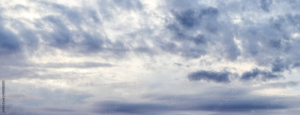 Fototapeta premium Overcast grey-blue sky with dark clouds of various shapes, panoramic view, natural lighting