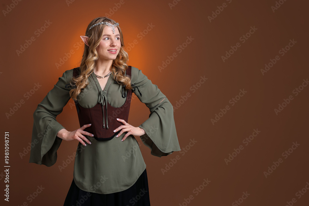 Fototapeta premium Portrait of beautiful elf girl on brown gradient background, space for text