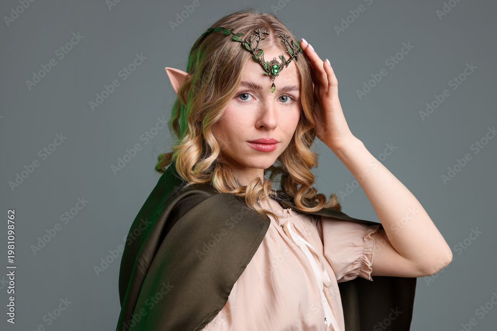 Fototapeta premium Portrait of beautiful elf girl on grey background