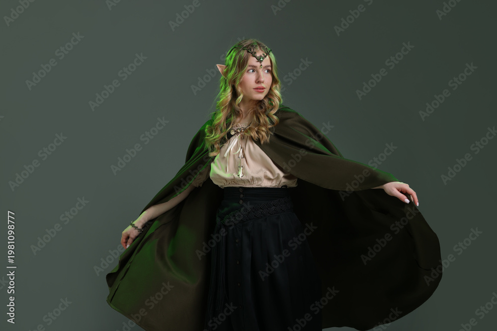 Fototapeta premium Beautiful girl dressed as elf on grey background