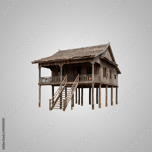 Traditional authentic wooden stilt house with thatched roof isolated on a clean neutral gray background