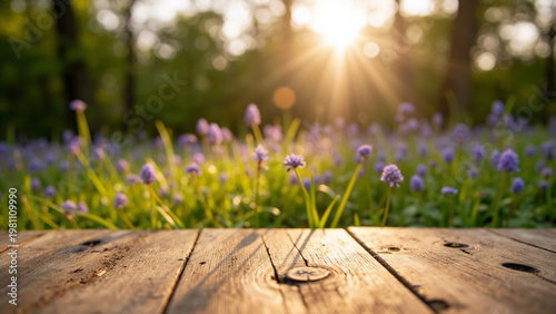 Wooden table with blurred flower garden and sunlight, natural product display background