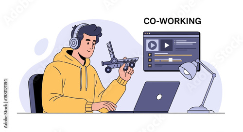 Co-working space: Young man with headphones working on laptop and model airplane
