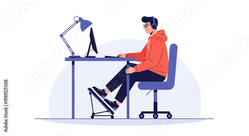 Young man with headphones working on computer at desk with foot pedal