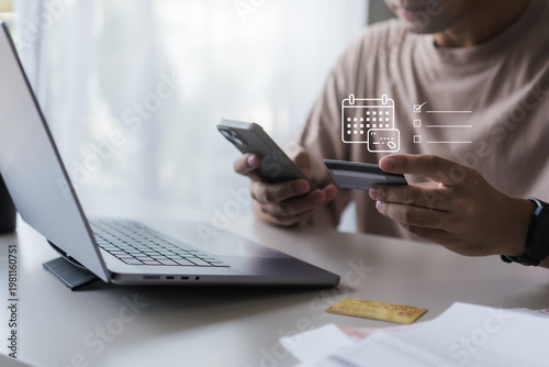 Man checking mobile payment with smartphone credit card for online payment schedule. payment reminder. fintech planning, personal finance, subscription bill, online purchase.