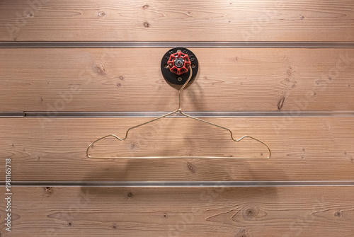 cloth hanger on old open-shut knob on wooden background