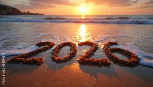 Numbers 2026 drawn on wet sand beach at sunset. Waves gently wash over sand inscription near calm ocean water, signaling new year celebration.