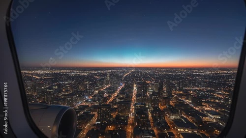 Aerial View of Cityscape at Sunset from Airplane Window.