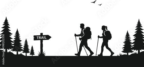 Silhouettes of a couple hiking in the forest