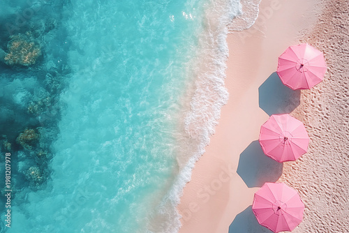 A stunning top view captures soft pink umbrellas along a tropical shoreline with crystal clear turquoise water. Summer travel and luxury beach escape create a vibrant vacation concept.