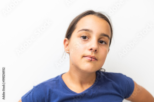 Εκτύπωση καμβά Closeup of a young teen girl's visage with piercing hanging from her lip