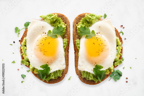 Slika na platnu Healthy avocado toast with sunny side up fried eggs on sourdough bread