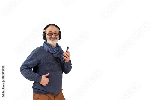 A cheerful gray-haired man listens to music on headphones. He holds a smartphone in his hand. Png.