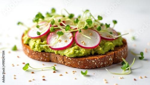 Avocado toast on multigrain bread topped with radish slices and sprouts. This healthy, tasty snack is perfect for breakfast, lunch or a light meal.