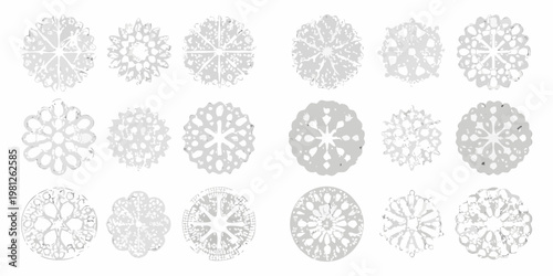 Collection of delicate intricately designed paper snowflakes on a white background