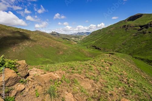 View along a grass covered ridge in the Drakensberg Mountains of the Golden Gate National Park, South Africa, on a sunny summer’s day. 