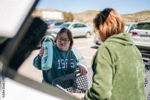 Woman with down syndrome putting detergent in car