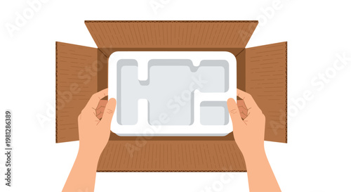 Two hands carefully place a custom white styrofoam protective insert into an open brown corrugated cardboard box from a high-angle top-down perspective view.