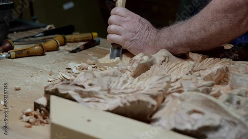 Handcrafted detailed carving, Skilled worker etching decorative wood design accurately, Detailed view capturing artisan meticulously carving elaborate oak panel using chisel under studio