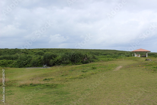 A green field under a cloudy winter sky at a southernmost point in Hateruma Island