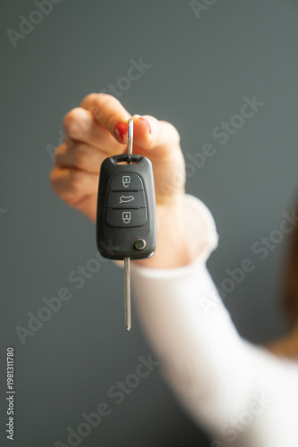 Car Key Remote Control with Key Extended in Hand Close-Up. Vehicle Access Concept