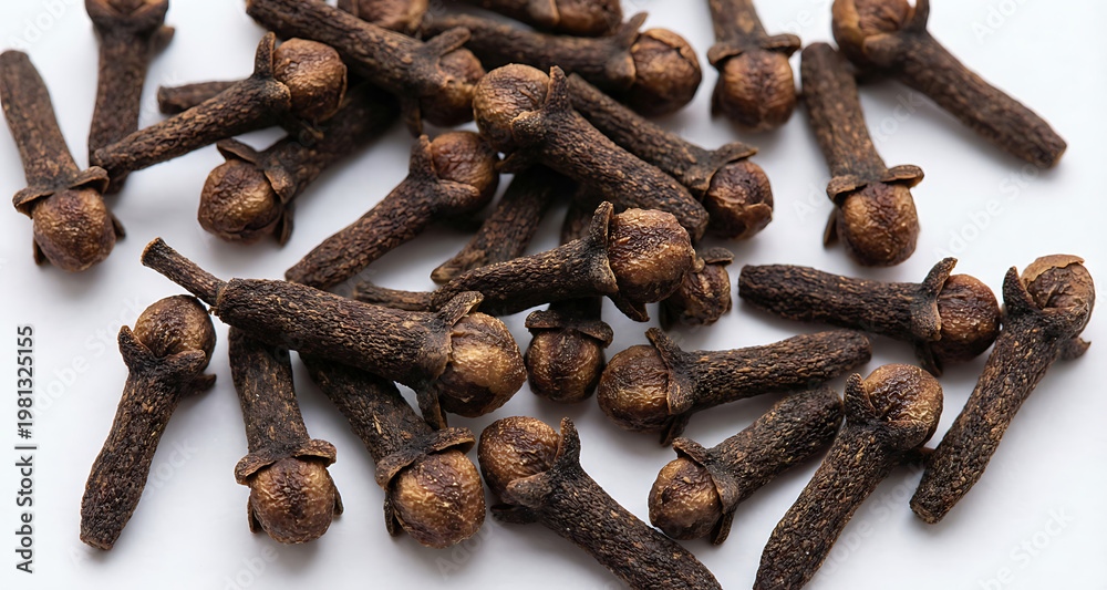 Fototapeta premium Whole Cloves Spices Scattered on White Background
